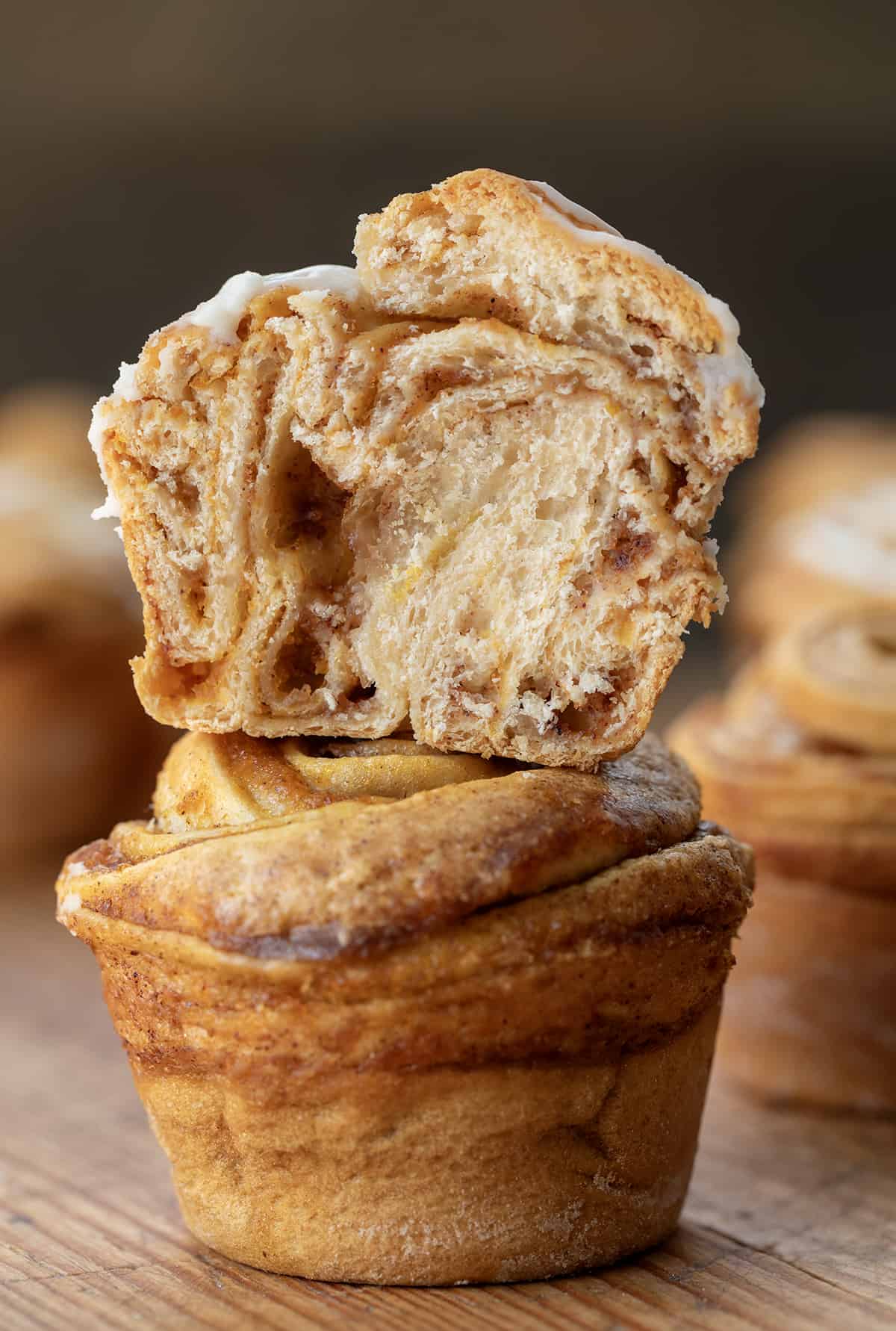 Stack of Pumpkin Spice Cruffins with top cruffin halved showing tender inside dough. 