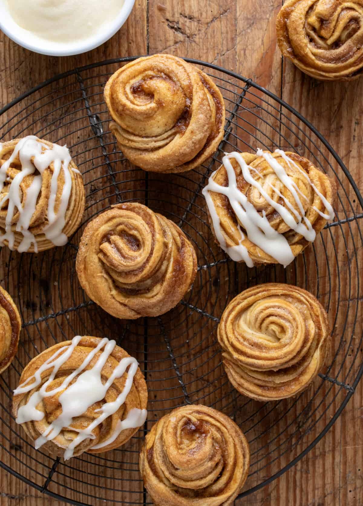 Pumpkin Spice Cruffins on a Rack some with cream cheese glaze and some plain.