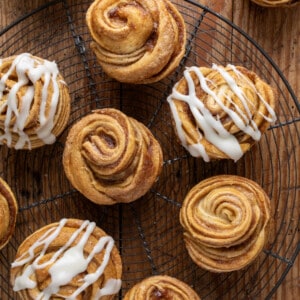 Pumpkin Spice Cruffins on a Rack some with cream cheese glaze and some plain.