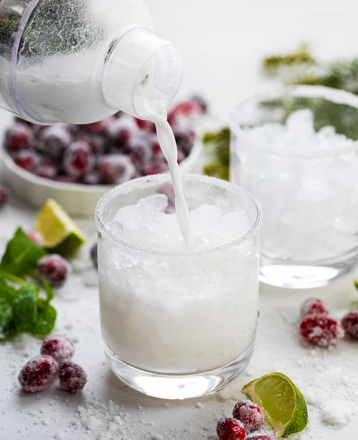 Pouring White Christmas Mojito into Glass.