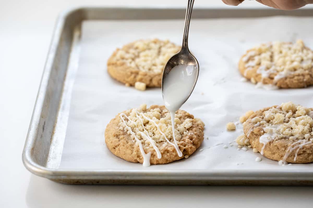 Drizzling glaze over Coffee Cake Cookies after baking.