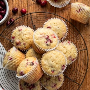 Cranberry Banana Muffins on a rack on a wooden table from overhead.