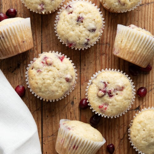 Cranberry Banana Muffins on a wooden table from overhead.