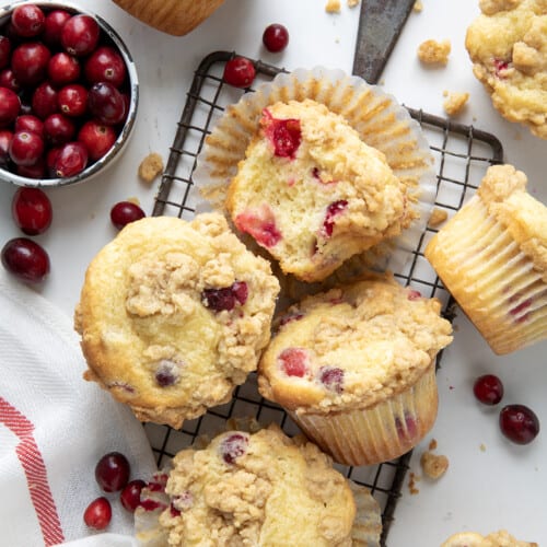 Cranberry Cream Cheese Muffins on a cooling rack on a white table from overhead.