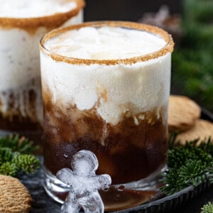 Gingerbread White Russian cocktail with gingerbread man icecube in front.
