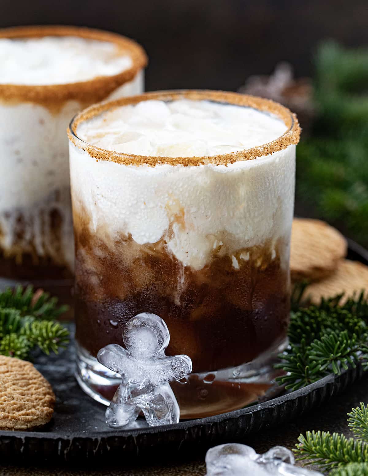 Gingerbread White Russian cocktail with gingerbread man icecube in front. 