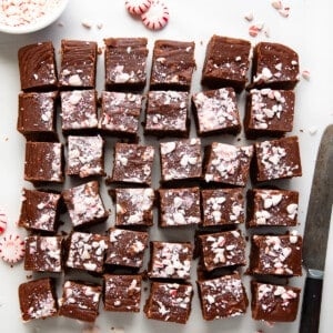 Pieces of Peppermint Fudge cut up on a white table.