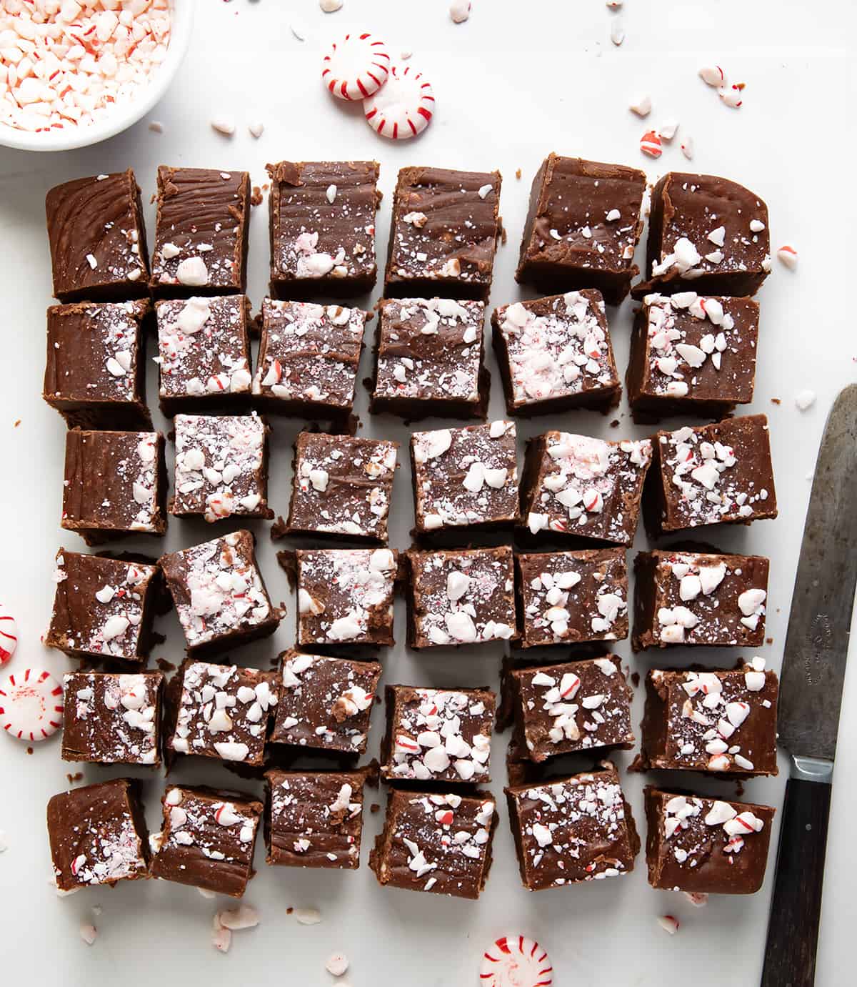 Pieces of Peppermint Fudge cut up on a white table. 