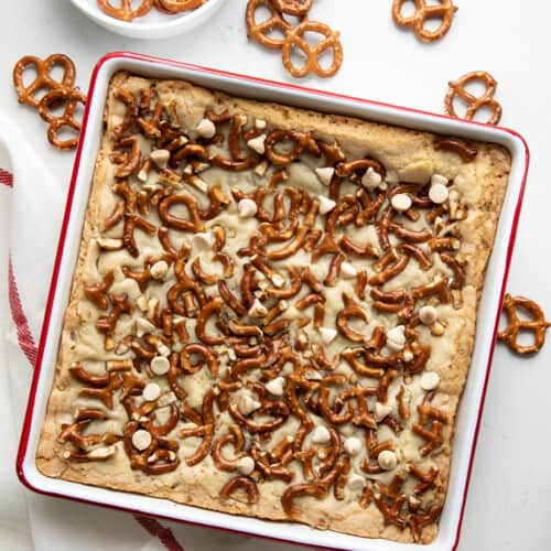 Pan of White Chocolate Pretzel Blondies on a white counter from overhead.