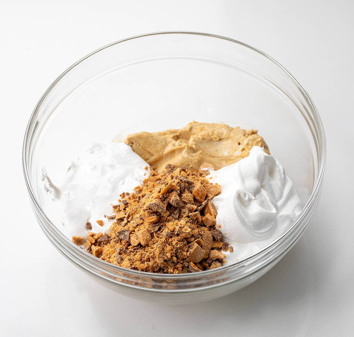 Ingredients used to make Butterfinger Dip in a bowl before mixing.
