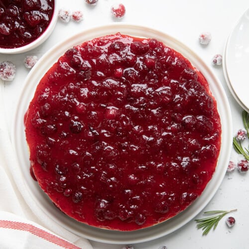 Whole Cranberry Cheesecake on a white table from overhead.
