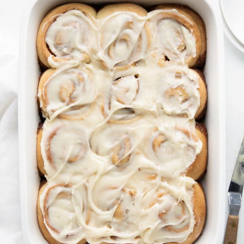 Gingerbread Cinnamon Rolls on a white counter from overhead.
