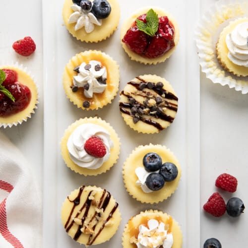 Close up of Mini Cheesecakes decorated with different toppings from overhead.