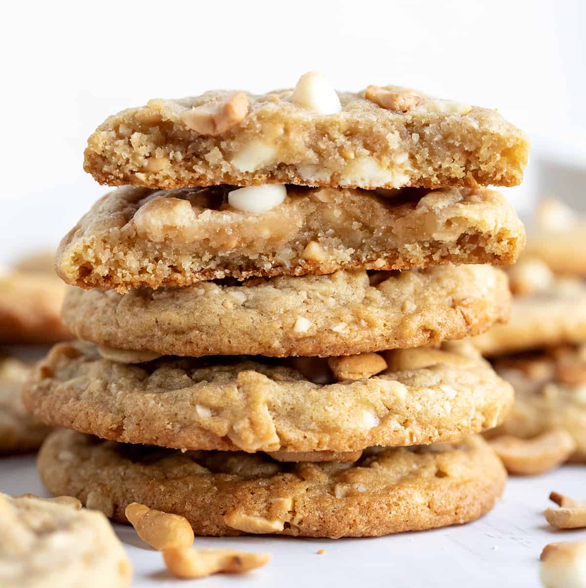 Stack of White Chocolate Cashew Cookies with top cookie halved.