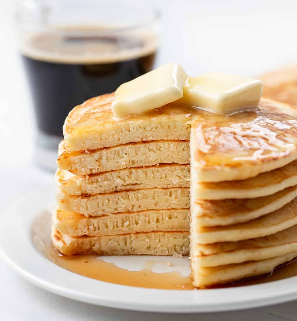Stack of Homemade Bisquick Pancakes cut into showing layers.
