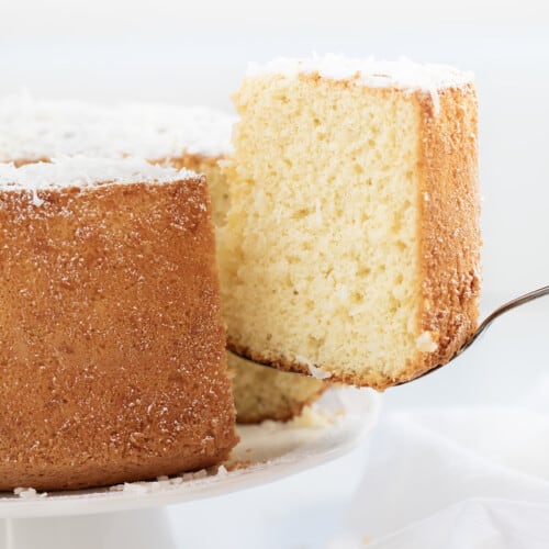Removing a piece of Coconut Chiffon Cake from the cake stand.