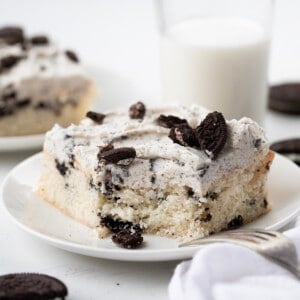 Piece of Cookies and Cream Sheet Cake on a plate with a bite removed.