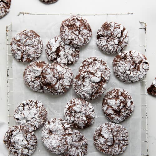 Baked Cool Whip Cookies on a cool rack on w white counter from overhead.