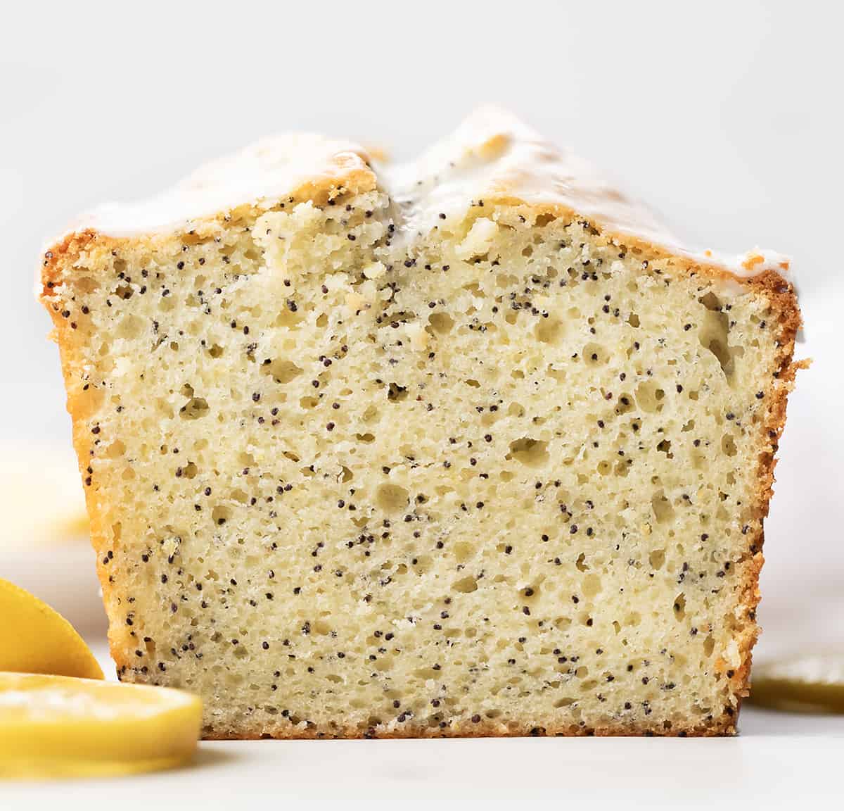 Loaf of Lemon Poppy Seed Bread cut in half showing inside texture.