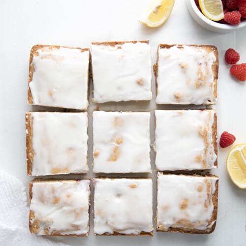 Raspberry Lemon Blondies that have been glazed and cut into slices from overhead.