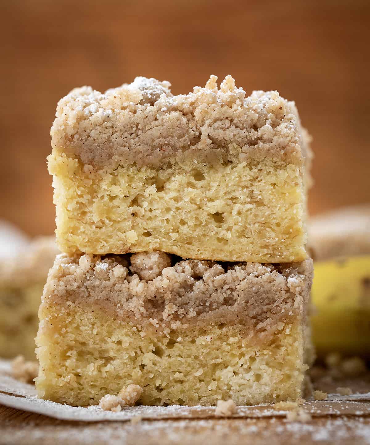 Pieces of Banana Crumb Cake stacked showing cake and crumb layers.