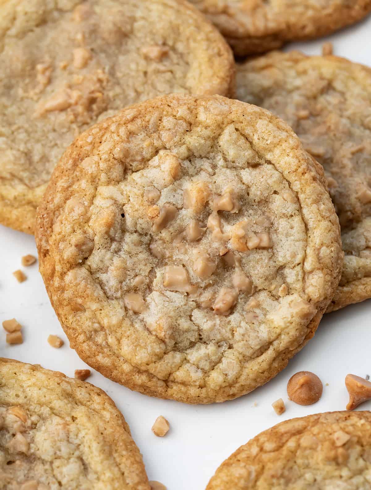 Close up of a Butterscotch Toffee Cookie surrounded by more cookies.