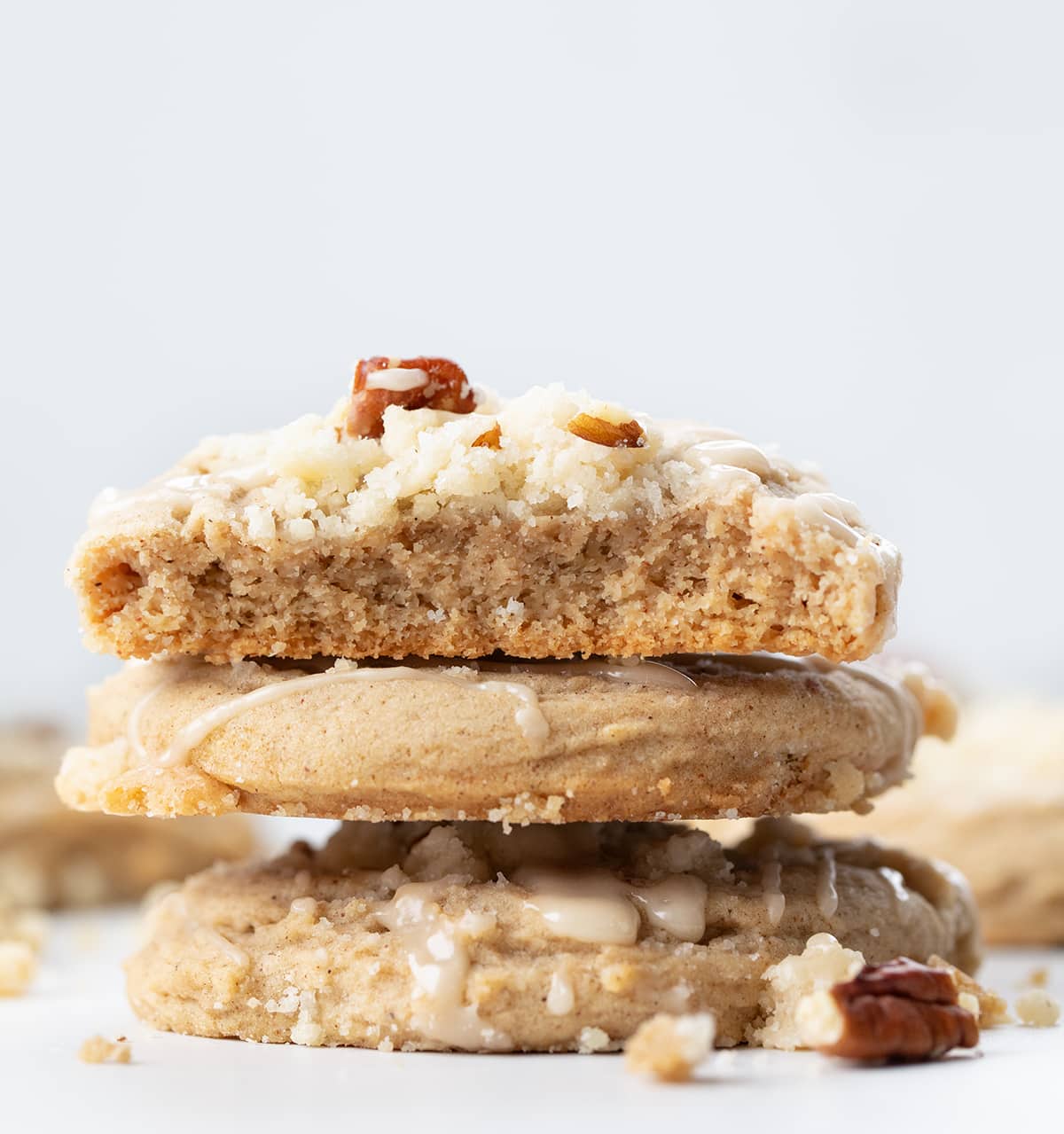 Stack of Maple Pecan Coffee Cake Cookies with top cookie halved showing inside.