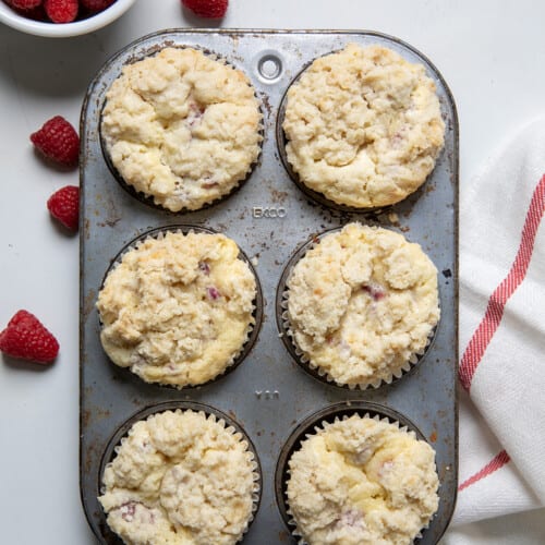 Pan of Raspberry Muffins on a white counter from overhead.