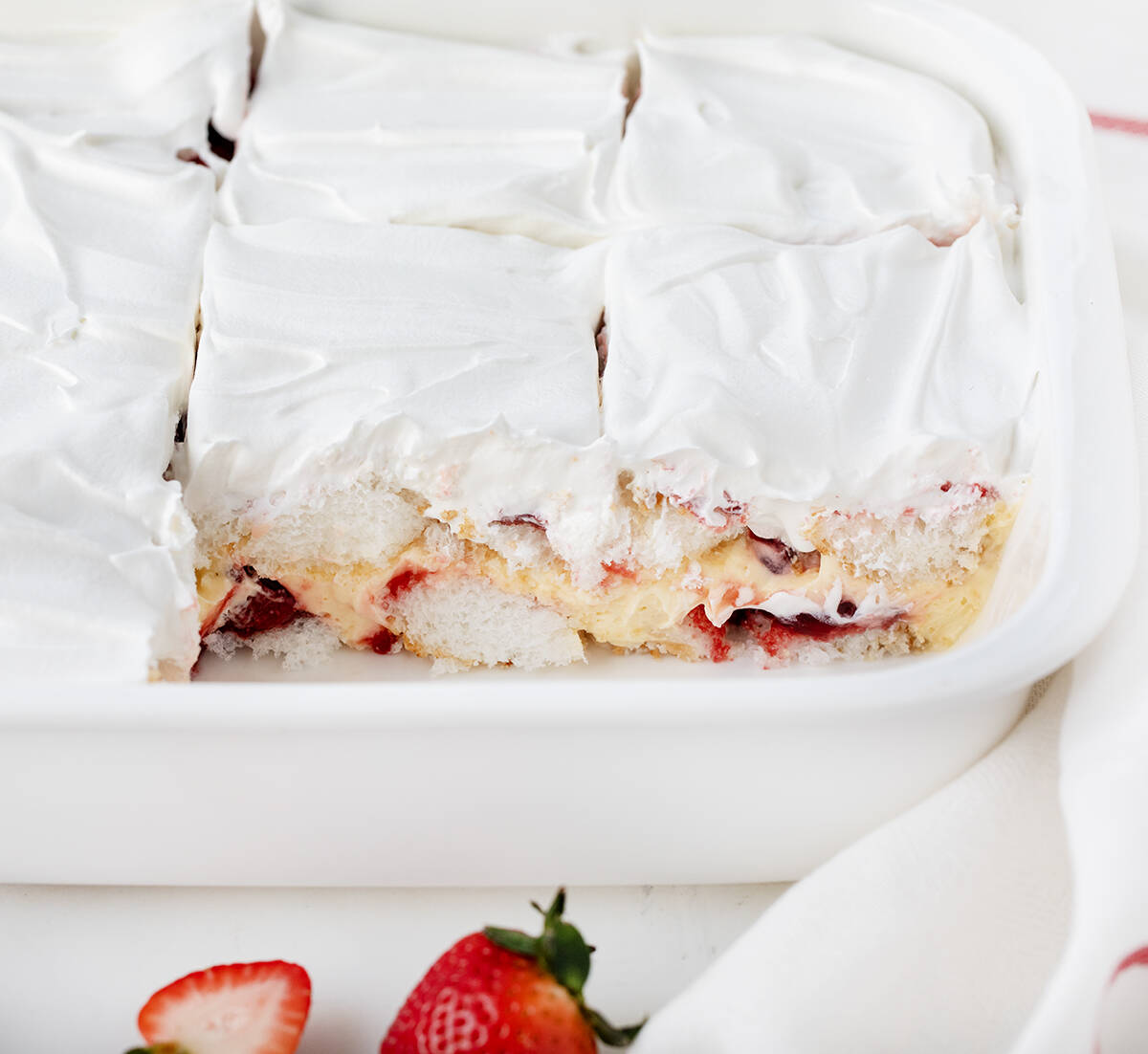 Pan of Strawberry Heaven Dessert with two pieces removed showing inside texture.