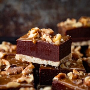 Salted Caramel Fudge Bars on a counter with one stacked up higher showing the texture.
