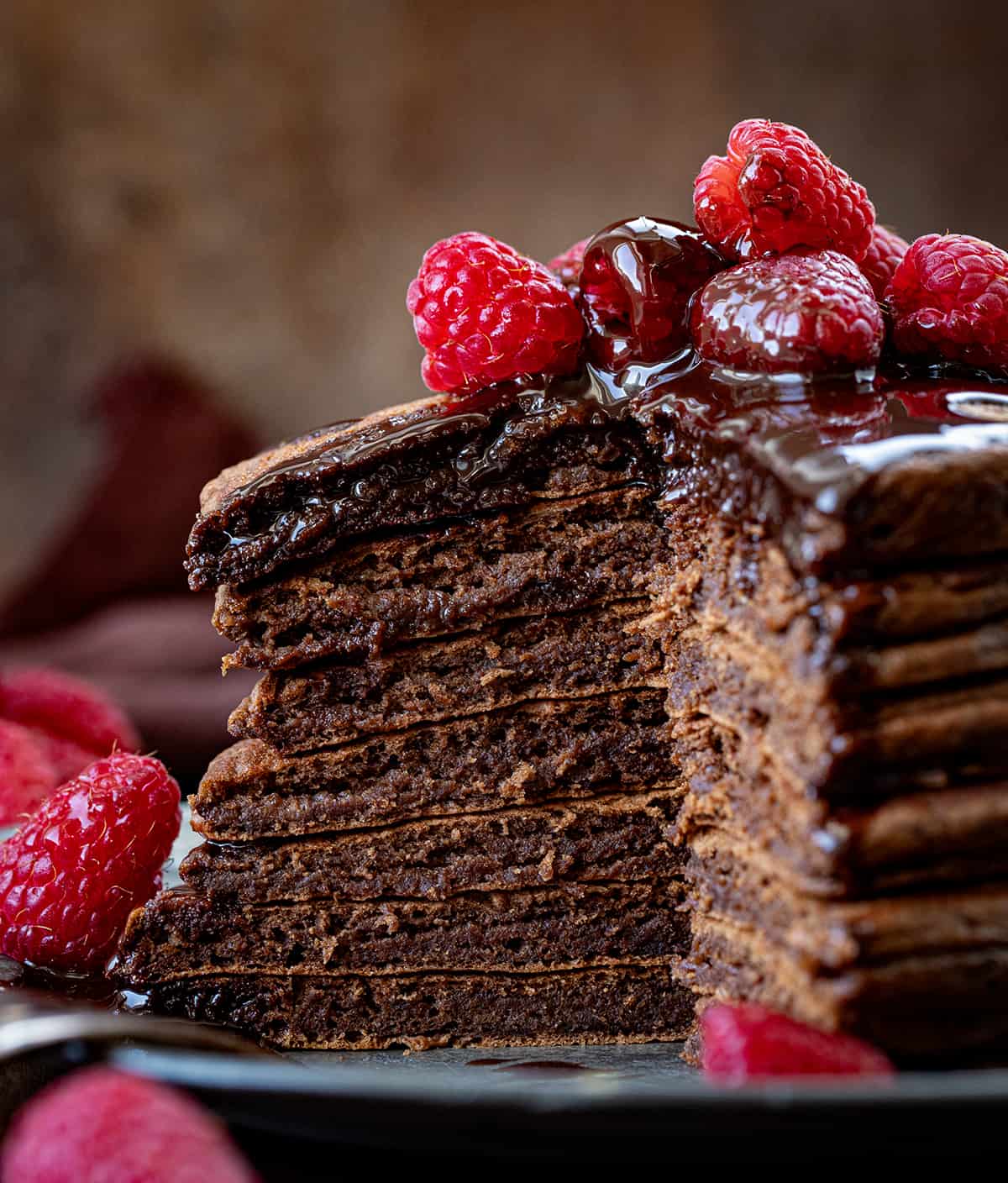 Stack of Chocolate Pancakes with bites removed showing inside texture.