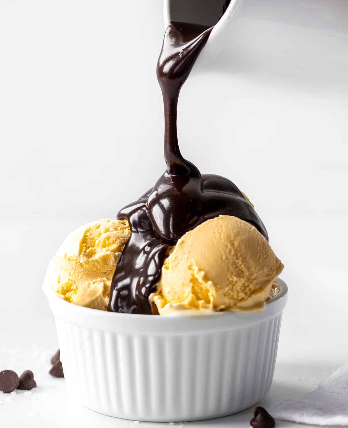 Pouring Salted Hot Fudge over ice cream.