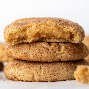 Stack of Peanut Butter Snickerdoodles with the top cookie with a bite taken out of it.
