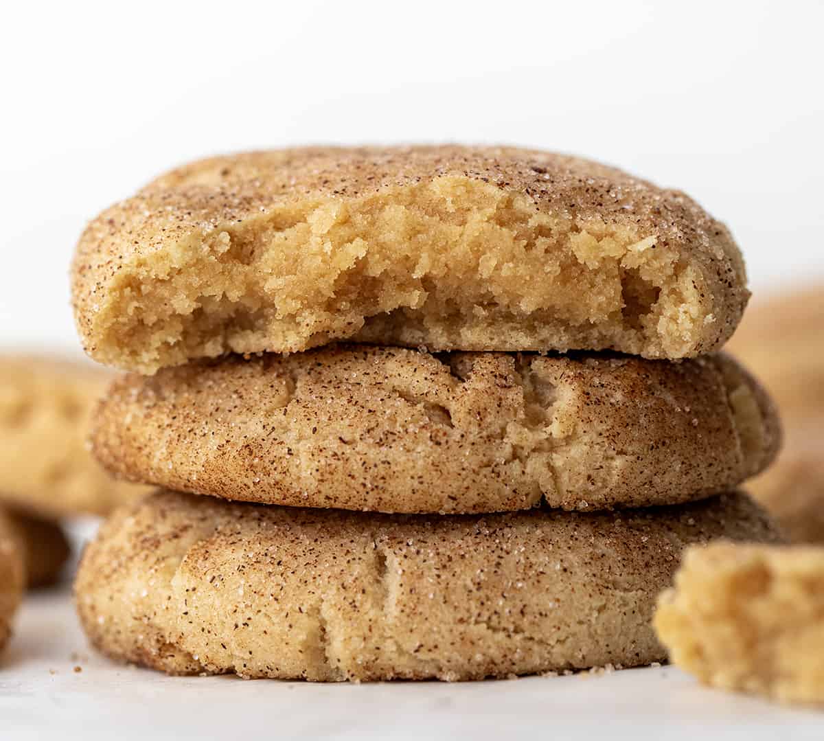 Stack of Peanut Butter Snickerdoodles with the top cookie with a bite taken out of it.
