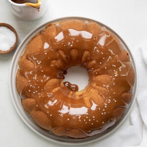 Salted Caramel Pound Cake on a white cake plate from overhead on a white counter.