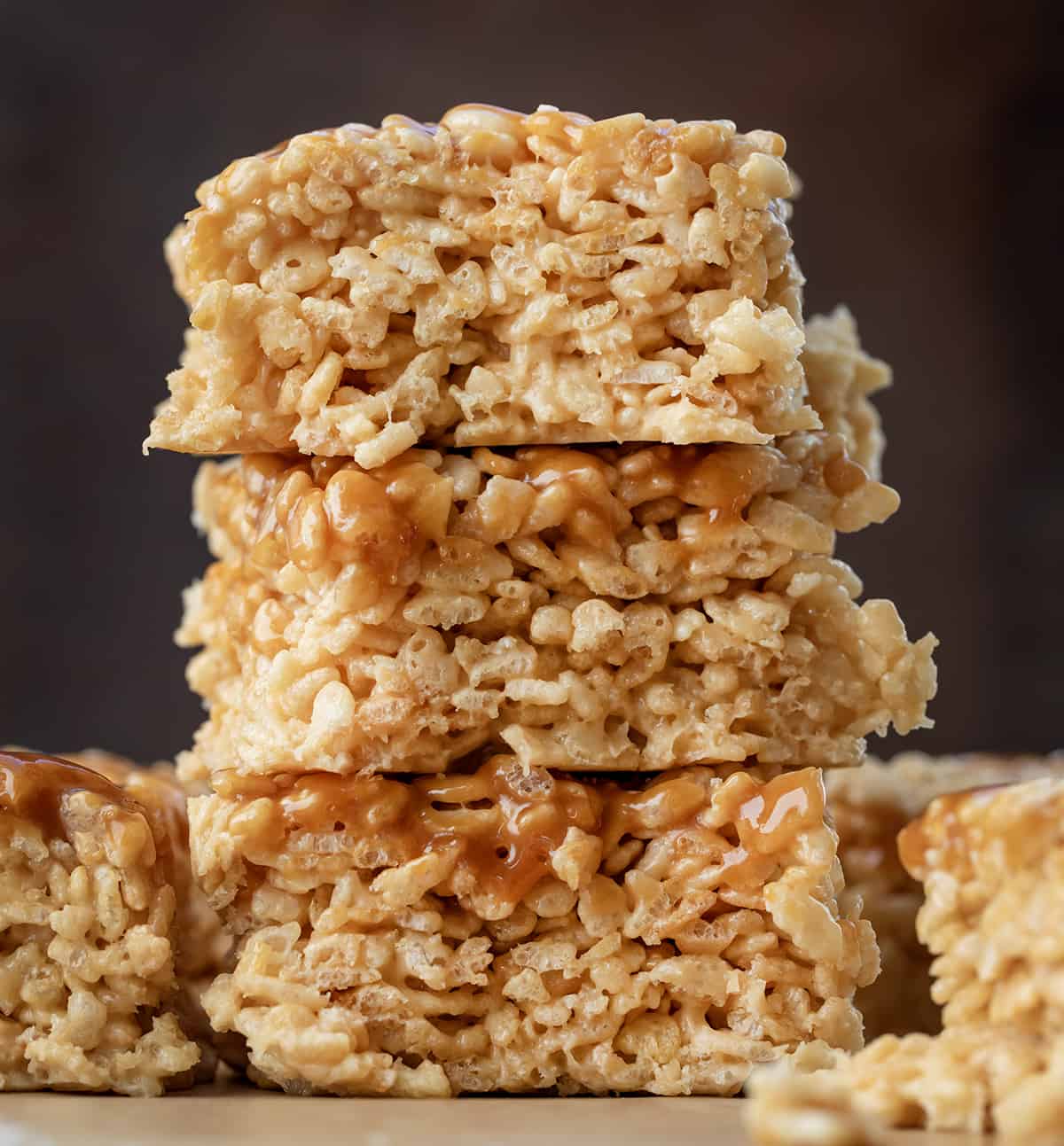 Stack of Salted Caramel Rice Krispie Treats on a wooden table.