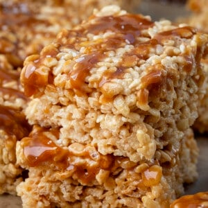 Small stack of Salted Caramel Rice Krispie Treats on a wooden table.