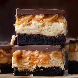 Stack of Snickers Brownies in front of other Snickers Brownies.