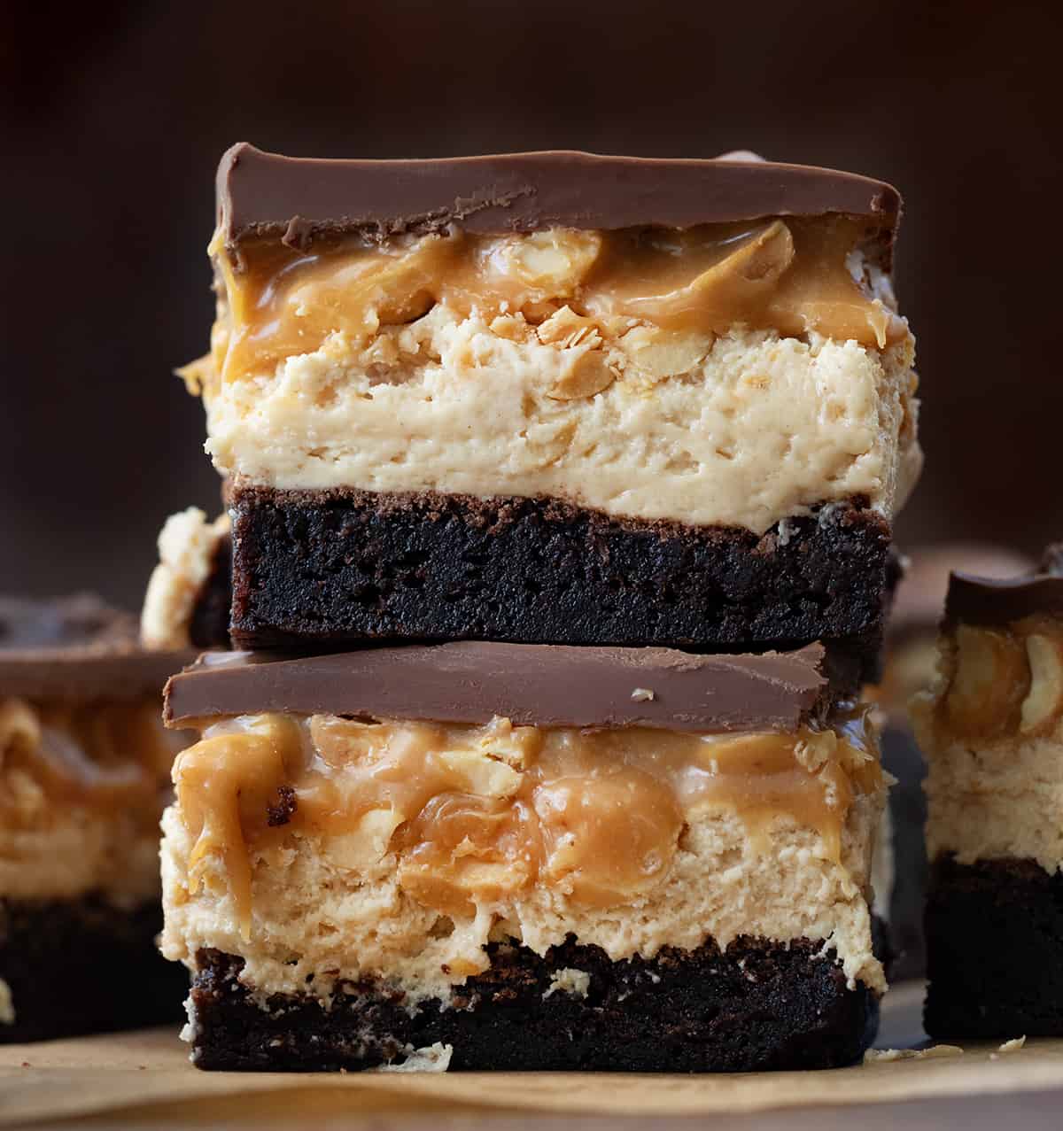 Stack of Snickers Brownies in front of other Snickers Brownies.