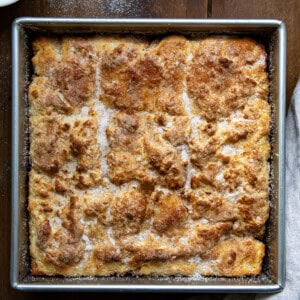 Pan of Cinnamon Sugar Butter Swim Biscuits on a wooden table from overhead.