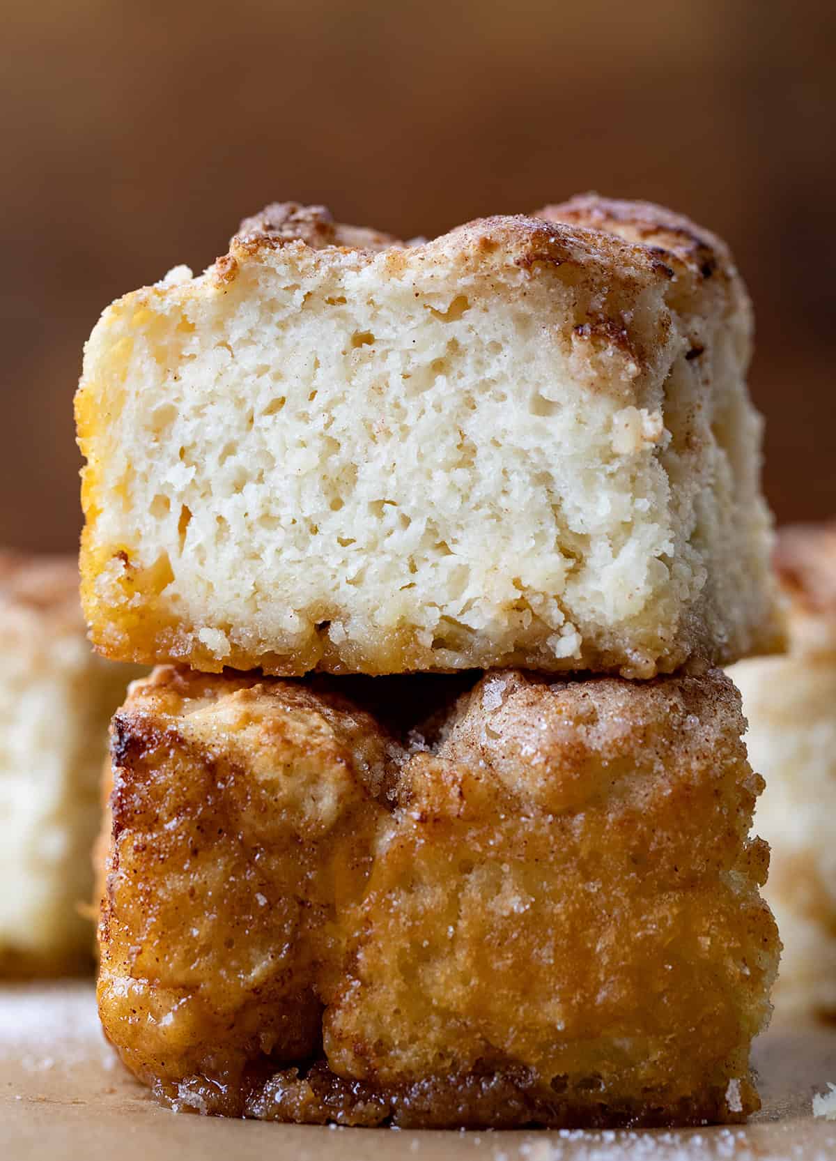 Cinnamon Sugar Butter Swim Biscuits stacked two-high on a wooden table.