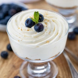 Cup of Easy Cheesecake Mousse with blueberries and mint.