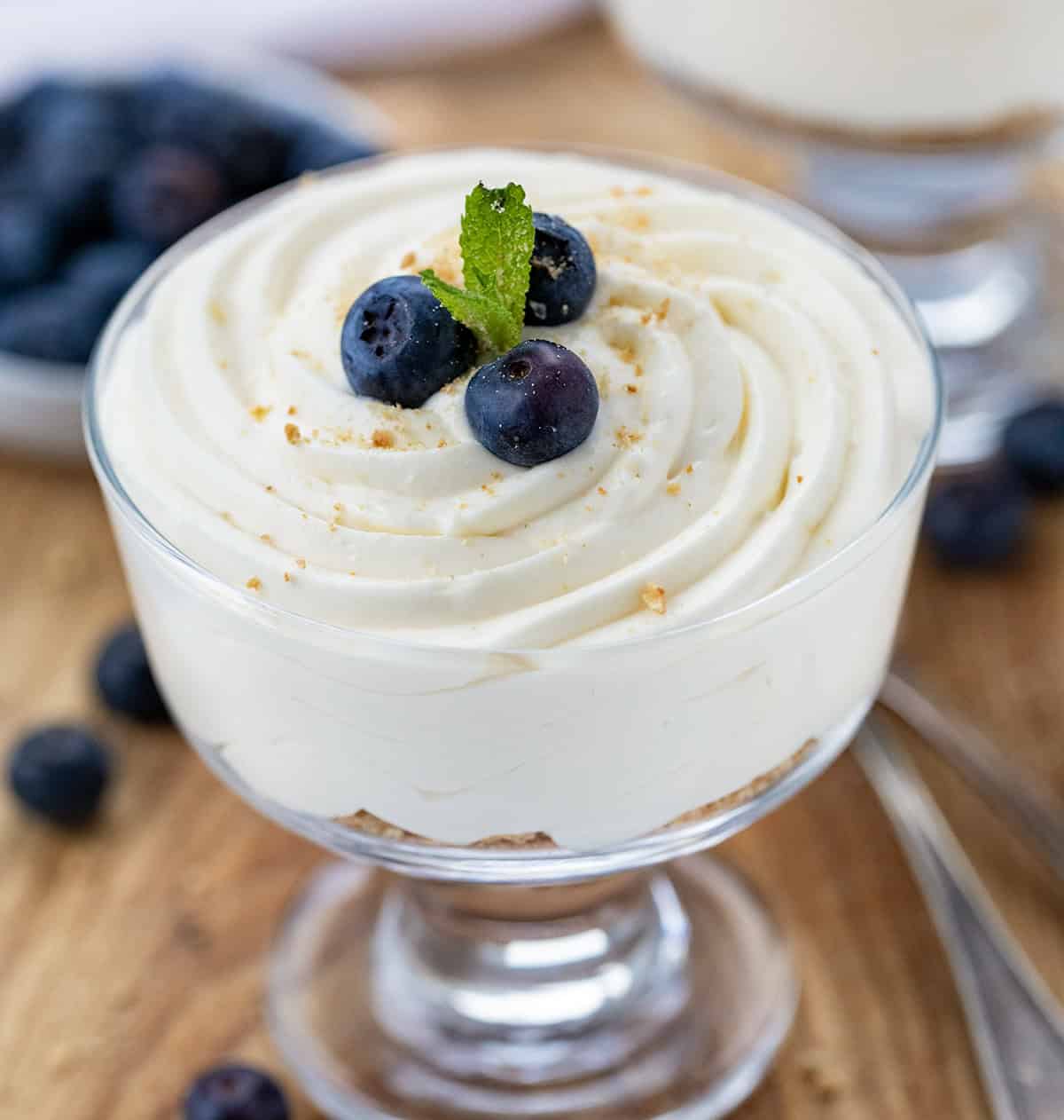 Cup of Easy Cheesecake Mousse with blueberries and mint. 