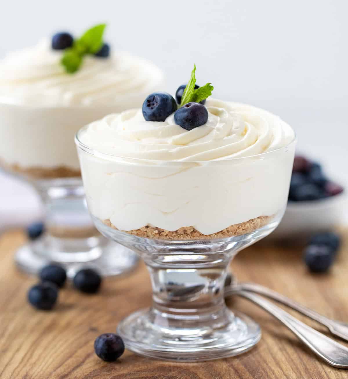 Cup of Easy Cheesecake Mousse with blueberries and mint.