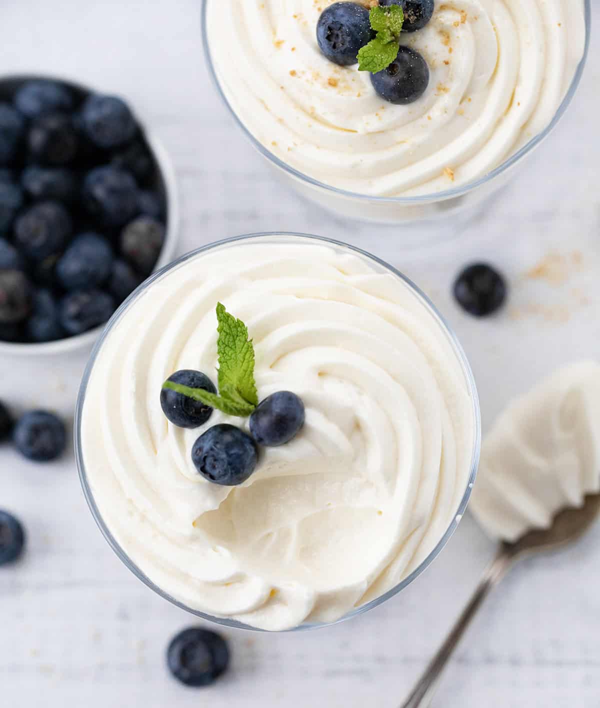 Easy Cheesecake Mousse in cups and a bite removed.