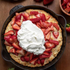 Skillet Strawberry Shortcake on a wooden table from overhead.