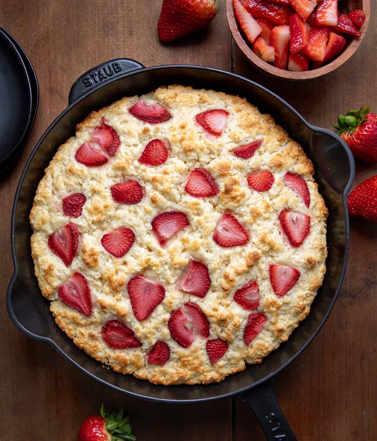Skillet Strawberry Shortcake on a wooden table from overhead.