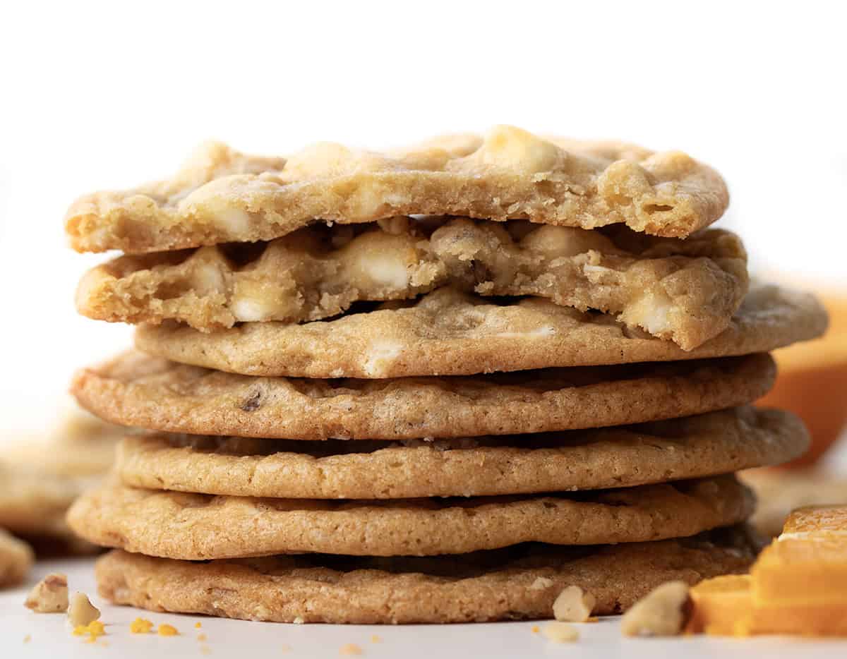 Stack of White Chocolate Orange Cookies with the top cookie broken.