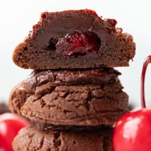 Stack of Chocolate Covered Cherry Cookies with top cookie cut in half.