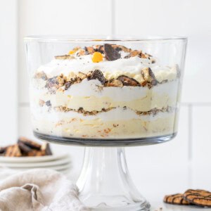 Cookie Salad Trifle in trifle dish on a white counter.